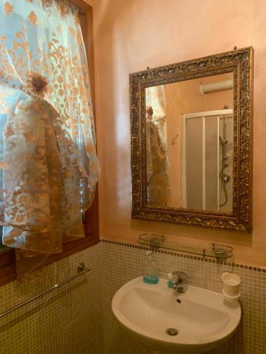 a bathroom with a sink and a mirror at B&B Dal Fiocinino in Comacchio