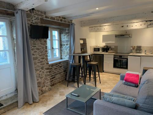 a living room with a couch and a table at Le Cap Solidor in Saint Malo