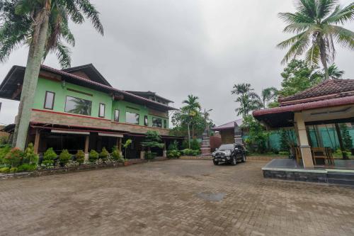 a car parked in front of a building at RedDoorz Plus @ Setiabudi Medan 4 in Sunggal