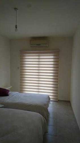 a bedroom with two beds and a large window at Sapphire L44 in Iskele