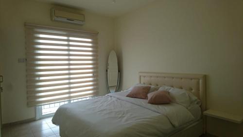 a bedroom with a bed with two pillows and a window at Sapphire L44 in Iskele