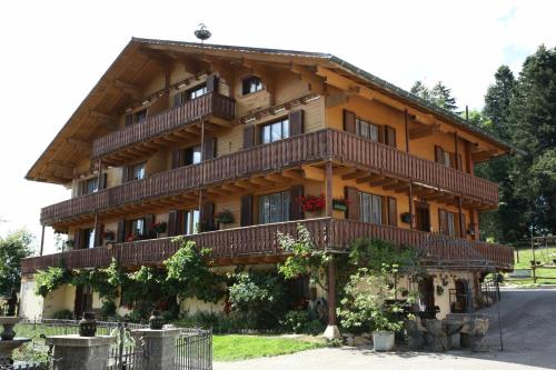a large wooden building with balconies on it at la Cibourg, Centre de vacances in Renan