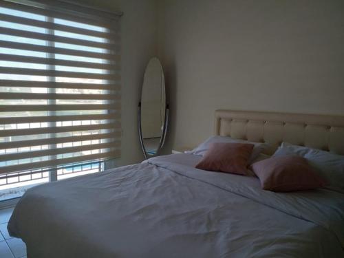 a bed with two pillows and a mirror in a bedroom at Sapphire L44 in Iskele