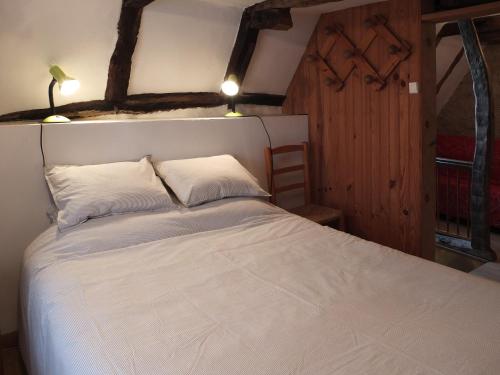 une chambre avec un lit blanc avec deux oreillers dans l'établissement chez capy, à Frayssinet
