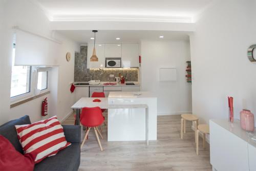 a kitchen and living room with a table and chairs at Casas da Avó V in Silveira