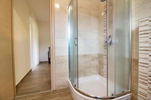 a shower with a glass door in a bathroom at Complex of 2 villas Banjole-Marisol with 2 private pools for up to 20 persons only 200m from the beach in Banjole