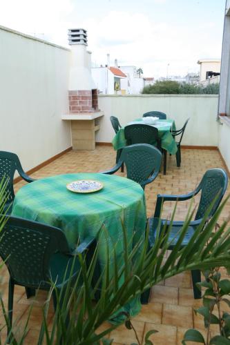 a patio with a table and chairs and a table and chairs at Il campanile in Soleto