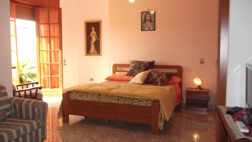 a bedroom with a bed and a couch at Il campanile in Soleto