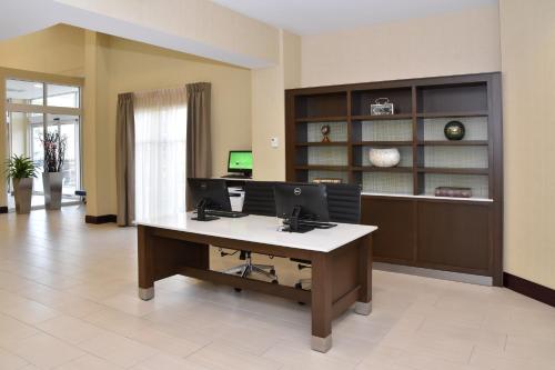 an office with a desk with two computers on it at Holiday Inn Canton-Belden Village by IHG in Canton
