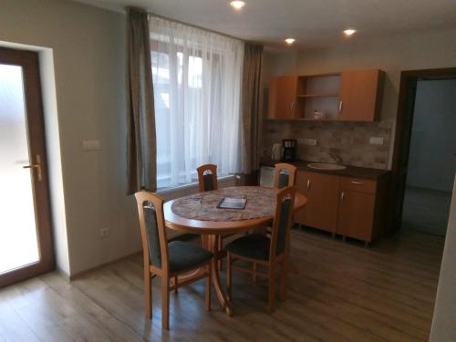 a kitchen with a table and chairs in a room at Appartment 2 in Braşov