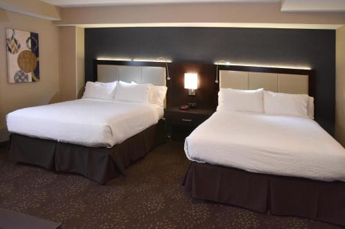 two beds in a hotel room with white pillows at Holiday Inn Canton-Belden Village by IHG in Canton