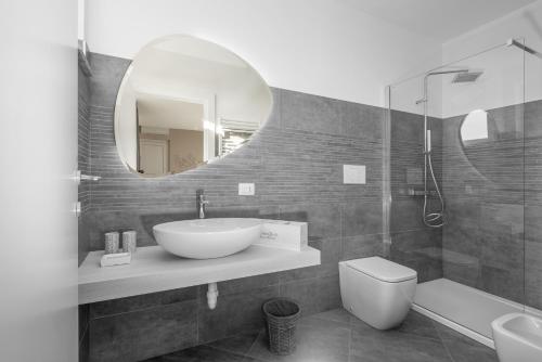 a bathroom with a sink and a mirror at VIVERONE LAKE ROOMS in Viverone