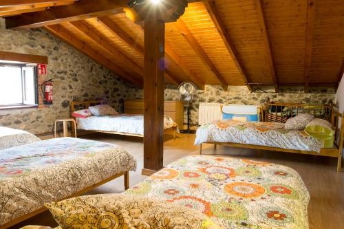 a room with three beds in a building at casa de maria in Hazas de Cesto