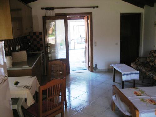 a kitchen and living room with a table and chairs at Sun House Apartments in Eftalou in Mithymna
