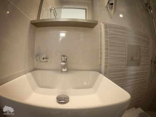 a bathroom with a white tub with a sink at Costa Point Chios in Chios
