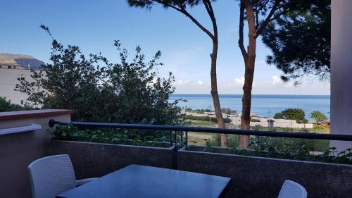 a balcony with a table and a view of the ocean at Addaura Village e Congressi in Mondello
