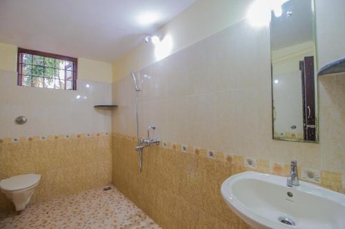 a bathroom with a sink and a toilet and a shower at Belleville - A Peaceful Holiday Home in Madgaon