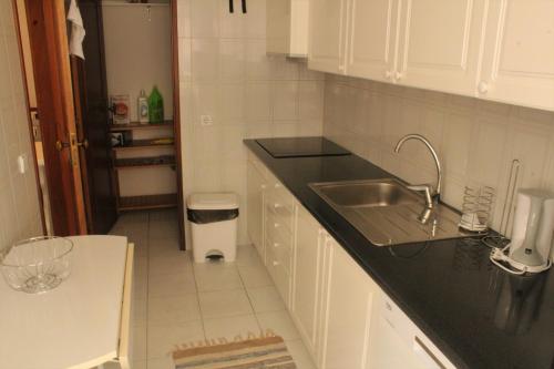 a kitchen with a sink and a counter top at 1A Atlantico - Casas & Papeis in Armação de Pêra