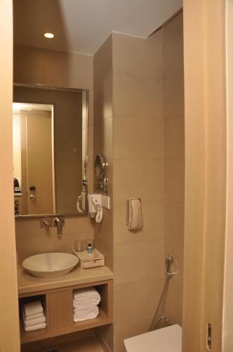 a bathroom with a sink and a mirror at Days Hotel Jaipur Tonk Road By Wyndham in Jaipur