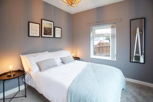 a bedroom with a white bed and a window at Host & Stay - Willow View in Saltburn-by-the-Sea