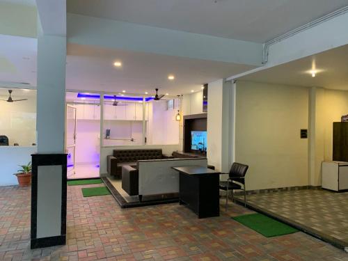 a lobby with a couch and a table at JK Rooms 126 Parashar Legacy - Opp Railway Station in Nagpur