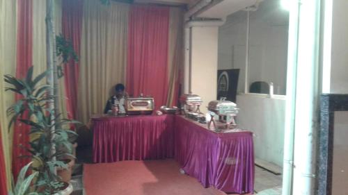 a room with a table with a purple table cloth at JK Rooms 126 Parashar Legacy - Opp Railway Station in Nagpur