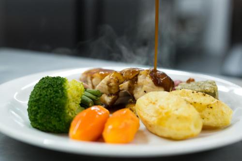 a plate of food with meat and vegetables on a table at Seacote Hotel in St Bees