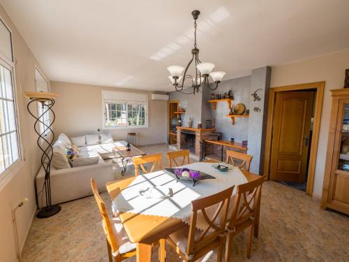 a dining room and living room with a table and chairs at Club Villamar - Admirada in San Poncio