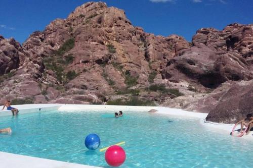 un grupo de personas jugando en el agua en una playa en Departamento en pleno centro, a metros de todo !, en San Rafael