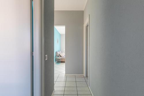a hallway with a door leading to a living room at Lido Apartments by Quokka 360 - 5 min from the centre and the Lugano Lido in Lugano