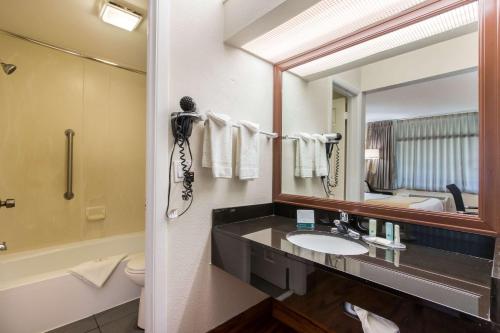 a bathroom with a sink and a mirror at Quality Inn Boca Raton University Area in Boca Raton