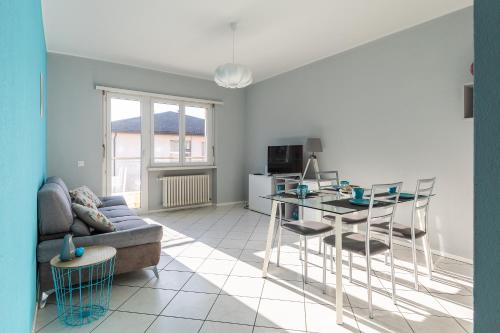 a living room with a couch and a table at Lido Apartments by Quokka 360 - 5 min from the centre and the Lugano Lido in Lugano