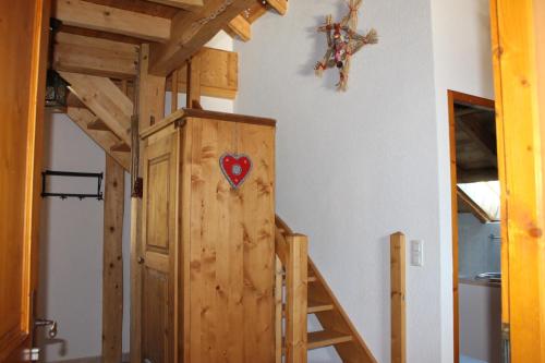 a room with a bunk bed and a wooden door at La Ferme de Sous-Lachat in Samoëns