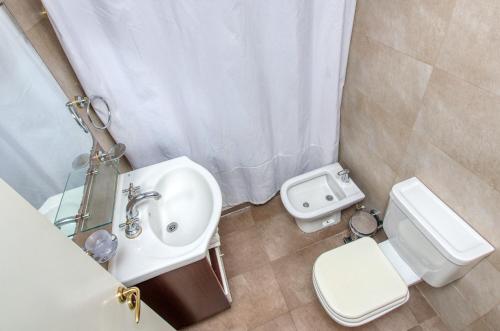 a bathroom with a sink and a toilet at Albar Club de Mar in Pinamar