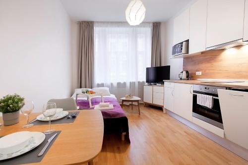 a kitchen and living room with a table and a dining room at Residential Barona Apartments in Riga Centre in Rīga