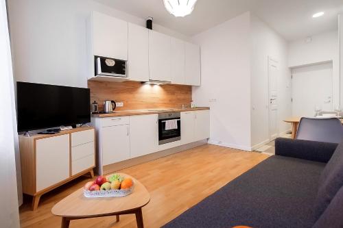 a living room with a bowl of fruit on a table at Residential Barona Apartments in Riga Centre in Rīga