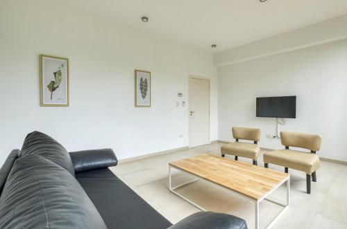 a living room with a couch and a table and chairs at Albar Club de Mar in Pinamar
