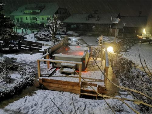 a bulldozer in a yard covered in snow at night at Hotel Schwarzbachhof in Lutago