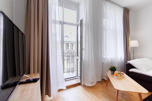 a living room with a bed and a large window at Residential Barona Apartments in Riga Centre in Rīga