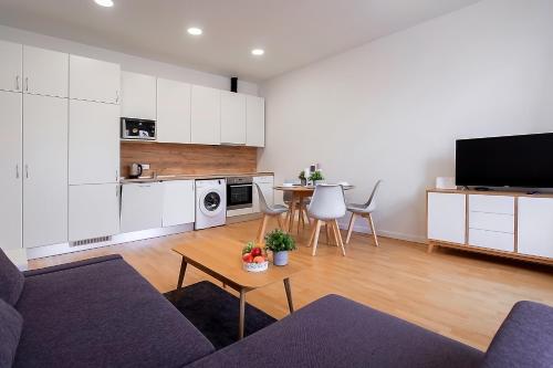 a living room with a couch and a table at Residential Barona Apartments in Riga Centre in Rīga