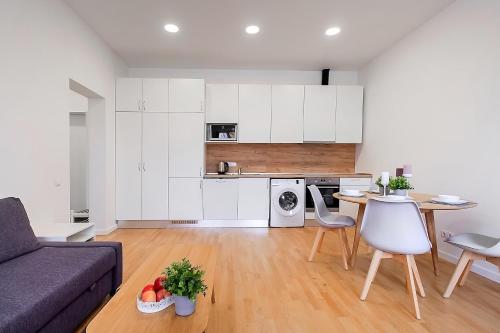 a living room with a couch and a table at Residential Barona Apartments in Riga Centre in Rīga