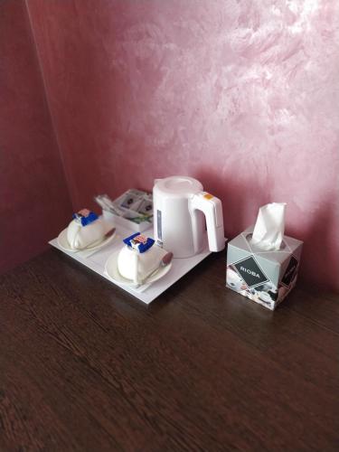a counter with two coffee makers and a box on it at VLG Hotel in Boryspilʼ