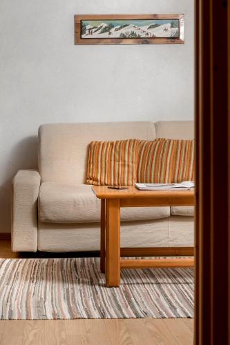 a living room with a couch and a coffee table at Chalet Stelle Di Neve in Bormio