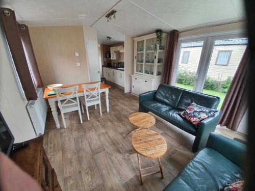 a living room with a couch and a table at Vakantiepark Kijkduin - 711 in The Hague