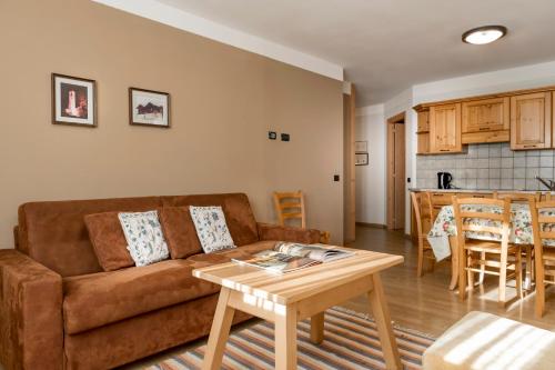 a living room with a couch and a table at Chalet Stelle Di Neve in Bormio