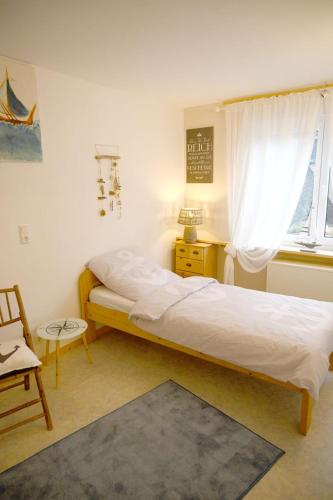 a bedroom with a large bed and a window at Haus Alfina in Alf