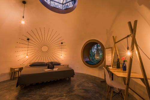 a bedroom with a bed and a round mirror at Nowhere in Bocas Town