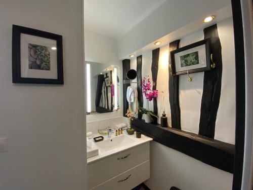 a bathroom with a sink and a mirror at Hôtel De La Cathédrale in Rouen