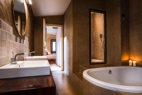 a bathroom with a large white tub and a sink at Cernobbio Town House in Cernobbio