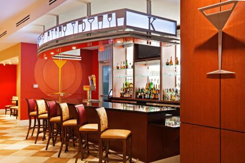 a bar in a restaurant with a bunch of chairs at Holiday Inn Rock Hill by IHG in Rock Hill